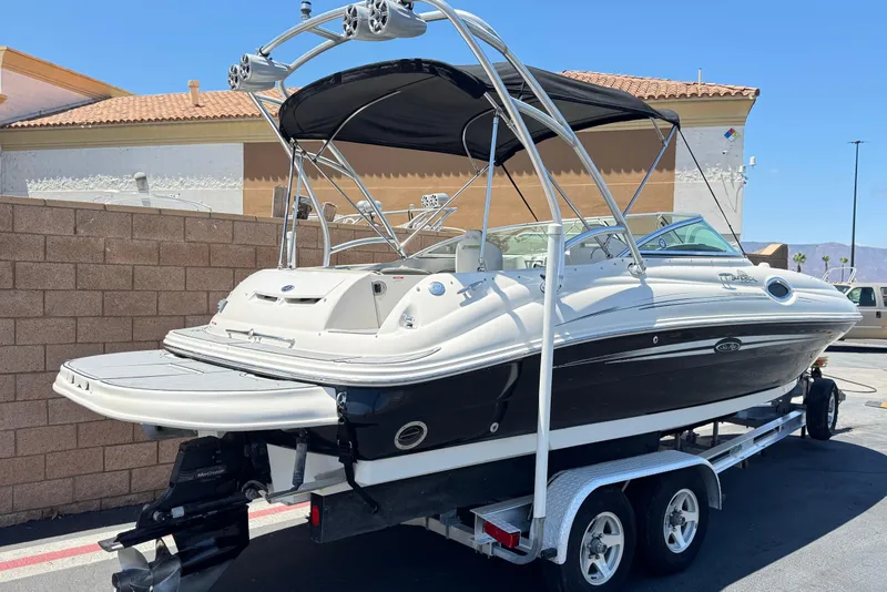 Slide: The Image of 2007 Sea Ray 240 Sundeck boat on trailer, featuring sleek design and black hull. - 5
