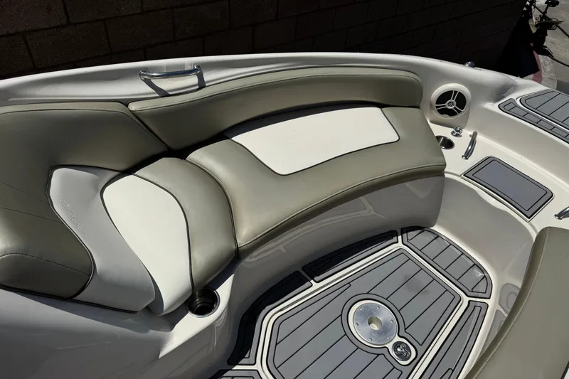 Slide: The Image of 2007 Sea Ray 240 Sundeck interior with cushioned seating and sleek design. - 20