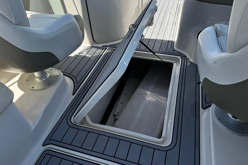 Slide: The Image of 2007 Sea Ray 240 Sundeck interior with open storage compartment and seating. - 35