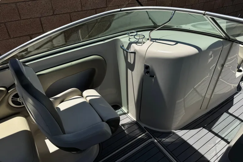 Slide: The Image of 2007 Sea Ray 240 Sundeck interior with seating and cup holders, showcasing sleek design. - 36