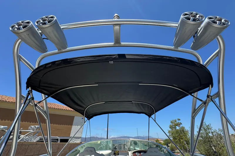 Slide: The Image of 2007 Sea Ray 240 Sundeck with speakers and canopy under clear blue sky. - 15