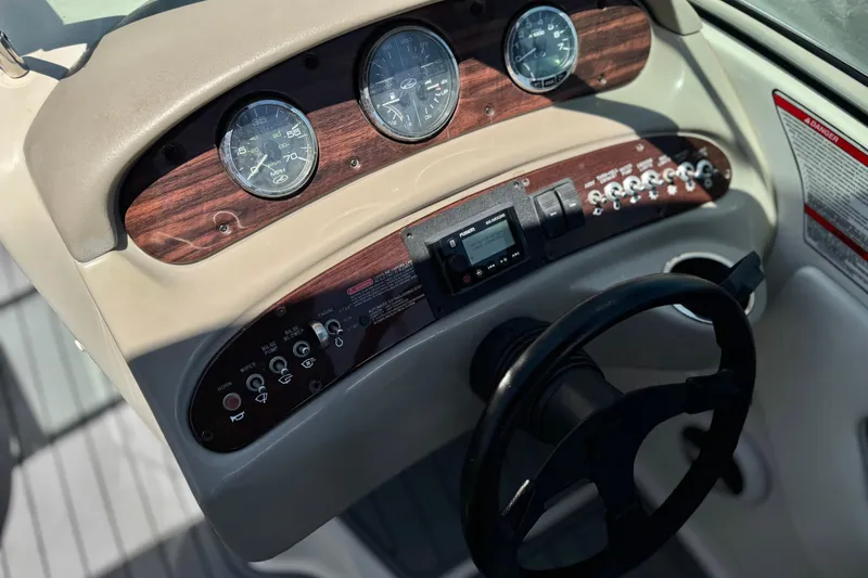 Slide: The Image of Dashboard of a 2007 Sea Ray 240 Sundeck boat with gauges and controls. - 41