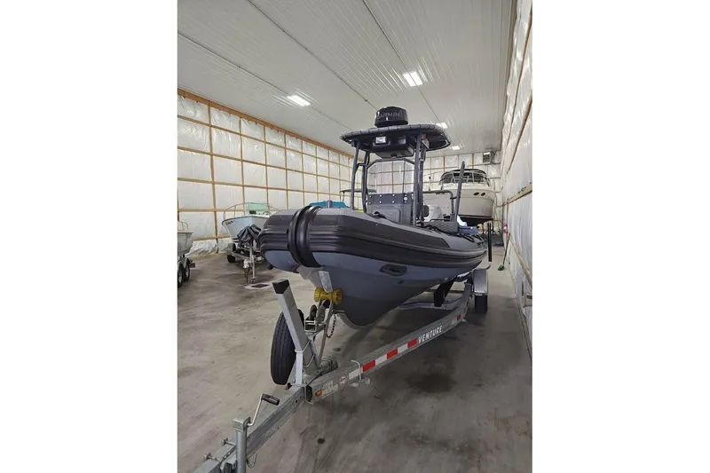 The Image of 2023 Highfield Patrol 600 boat on trailer in indoor storage facility. - 0