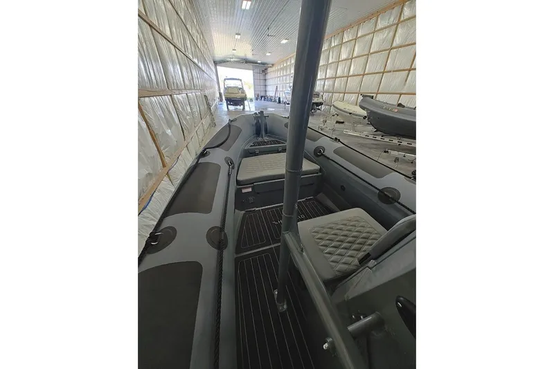 Slide: The Image of 2023 Highfield Patrol 600 boat interior in a storage facility. - 4