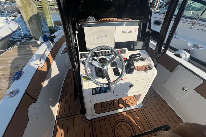 Slide: The Image of 2019 Sea Hunt Ultra 234 boat console with Garmin and Simrad navigation systems. - 12