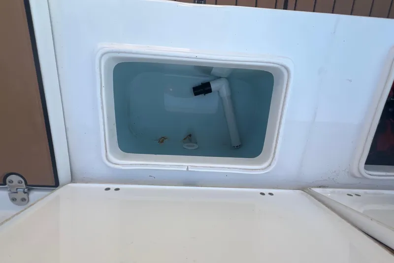 Slide: The Image of Livewell compartment on a 2019 Sea Hunt Ultra 234 boat, partially filled with water. - 10