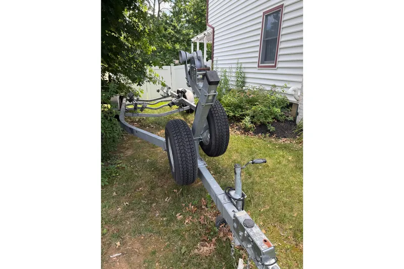 Slide: The Image of Boat trailer for 2019 Sea Hunt Ultra 234 parked beside a house. - 23