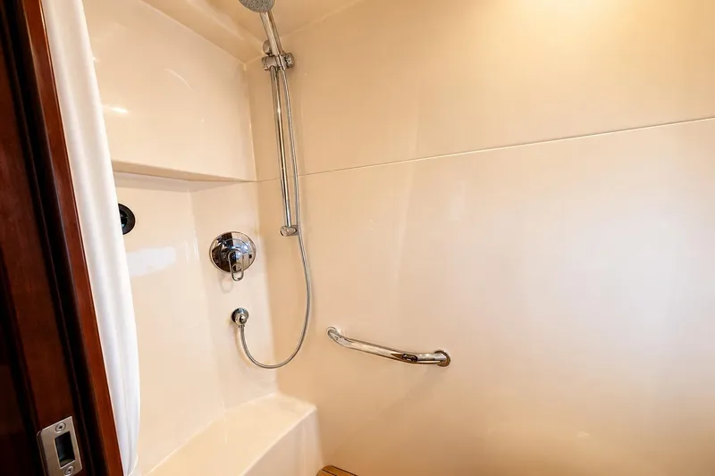 Slide: The Image of Shower area in 2007 Sea Ray 48 Sundancer yacht, featuring sleek fixtures and grab bar. - 16