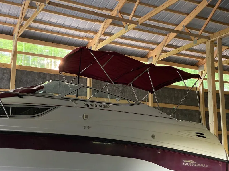 Slide: The Image of A 1997 Chaparral Signature 260 boat is in a covered area with a red canopy. - 3