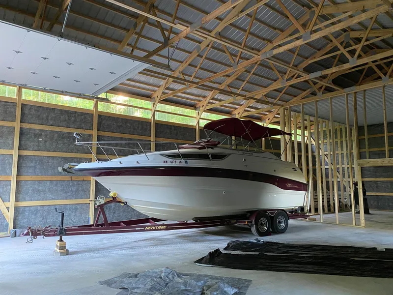 Slide: The Image of A 1997 Chaparral Signature 260 boat on a trailer inside a large shed. - 2