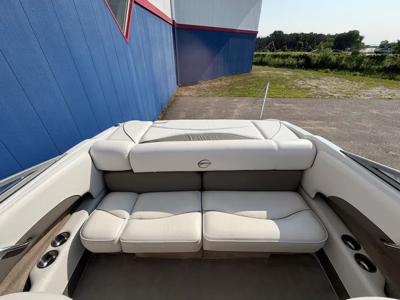 Slide: The Image of The image shows the stern of a 2006 Crownline 195 boat with beige upholstered seats. - 9