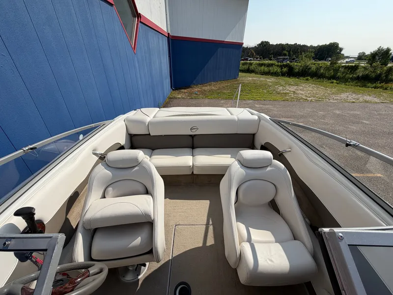 Slide: The Image of The image shows the cockpit of a 2006 Crownline 195 boat with white leather seating. - 24