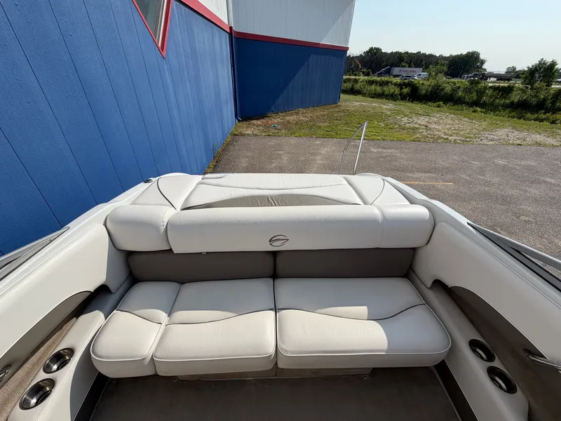 Slide: The Image of The image shows the cockpit of a 2006 Crownline 195 boat with white upholstery. - 23