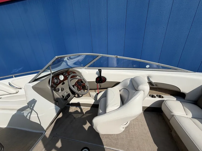 Slide: The Image of The image shows the cockpit of a 2006 Crownline 195 boat with white leather seats. - 14