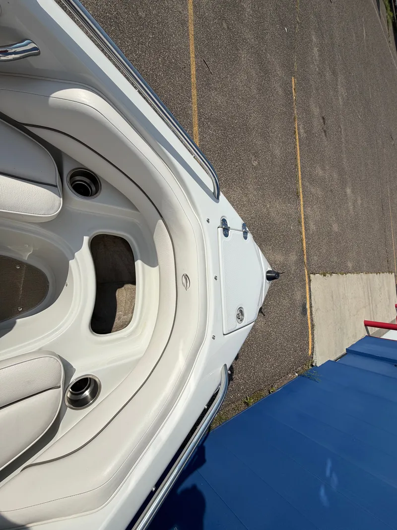 Slide: The Image of The image shows the bow deck of a 2006 Crownline 195 boat with white upholstery. - 21