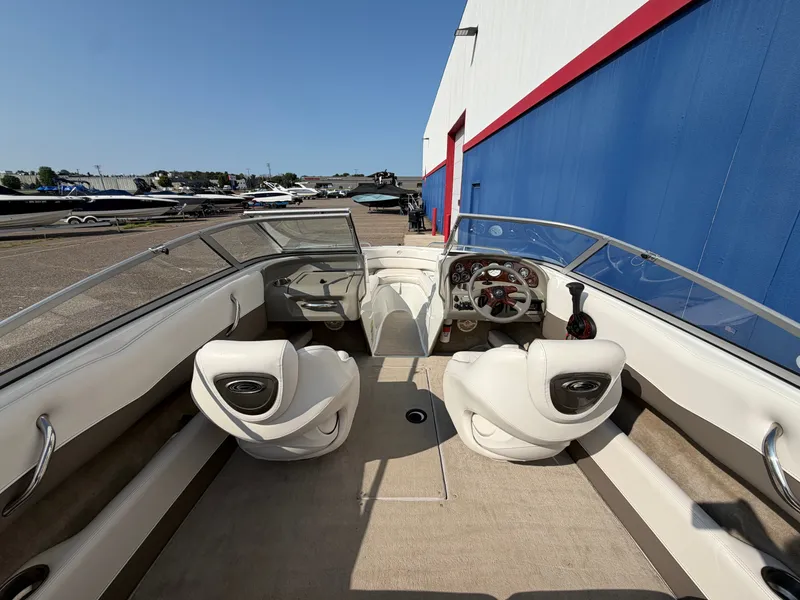 Slide: The Image of The image shows the cockpit of a 2006 Crownline 195 boat with beige seats and a steering wheel. - 8