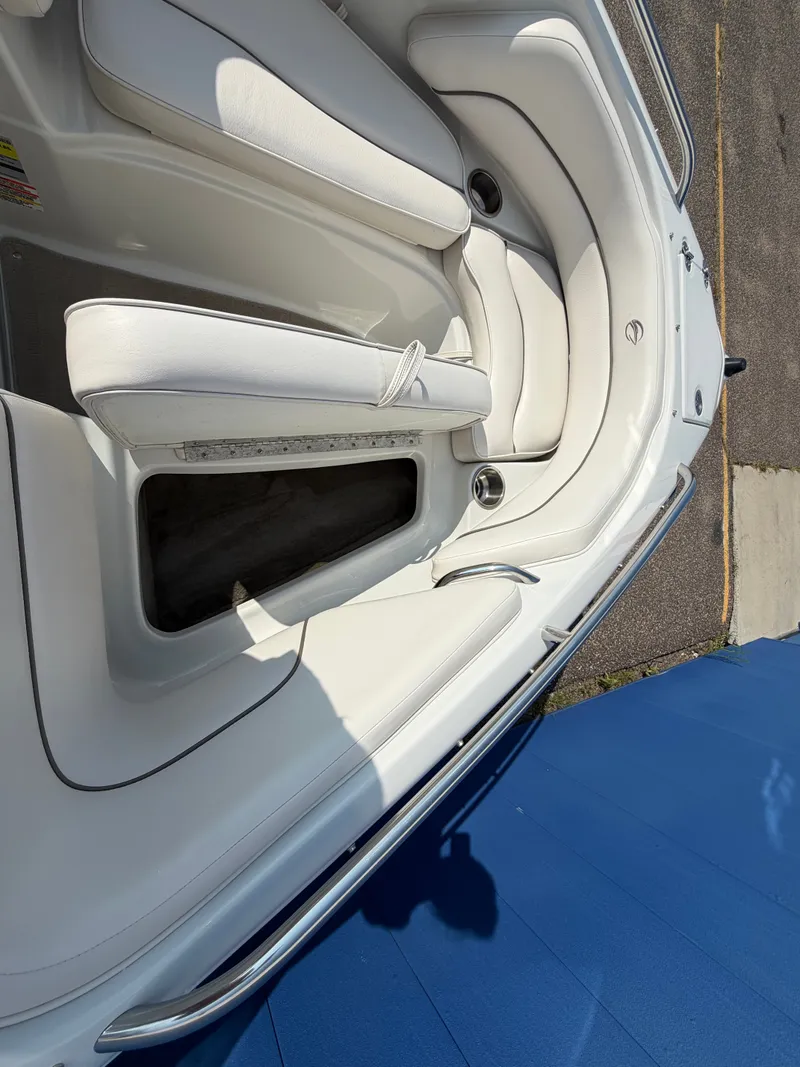 Slide: The Image of The image shows the white, cushioned interior of a 2006 Crownline 195 boat. - 22