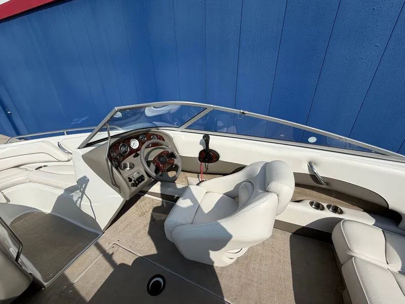 Slide: The Image of The image shows the cockpit of a 2006 Crownline 195 boat with white leather seats. - 15