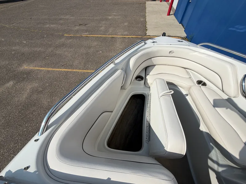 Slide: The Image of The image shows the white, cushioned bow seating area of a 2006 Crownline 195 boat. - 20