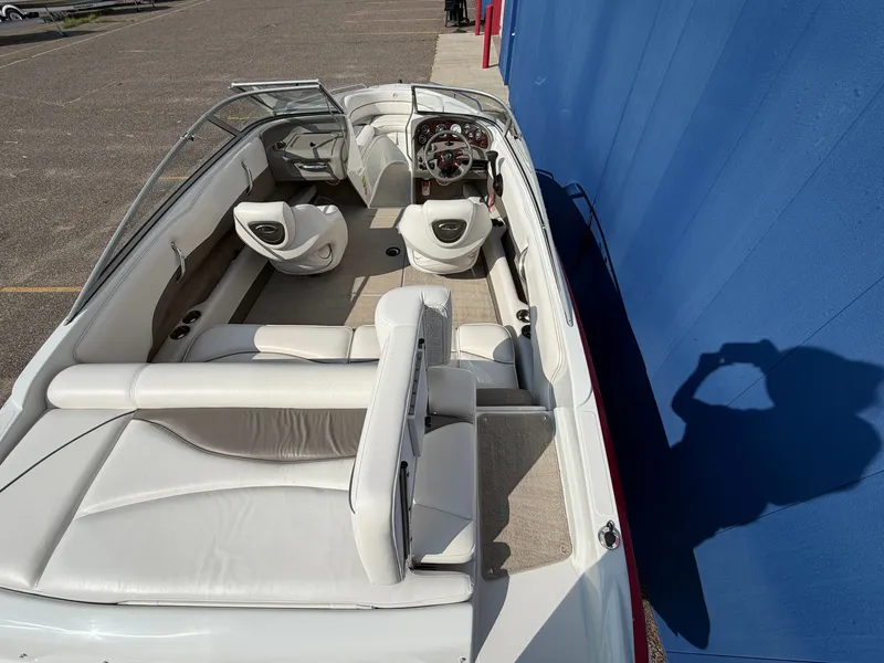 Slide: The Image of The image shows the interior of a 2006 Crownline 195 boat with white leather seats. - 10