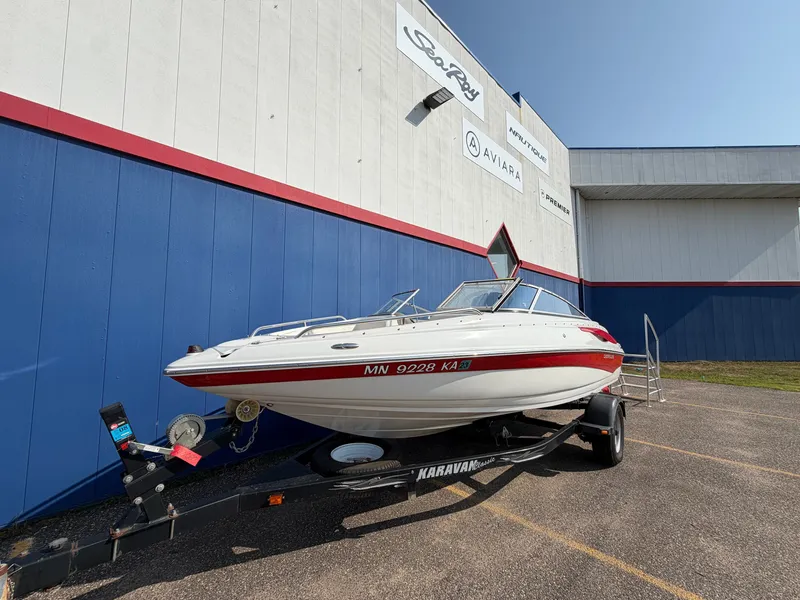 Slide: The Image of A 2006 Crownline 195 boat on a trailer in front of a building. - 4