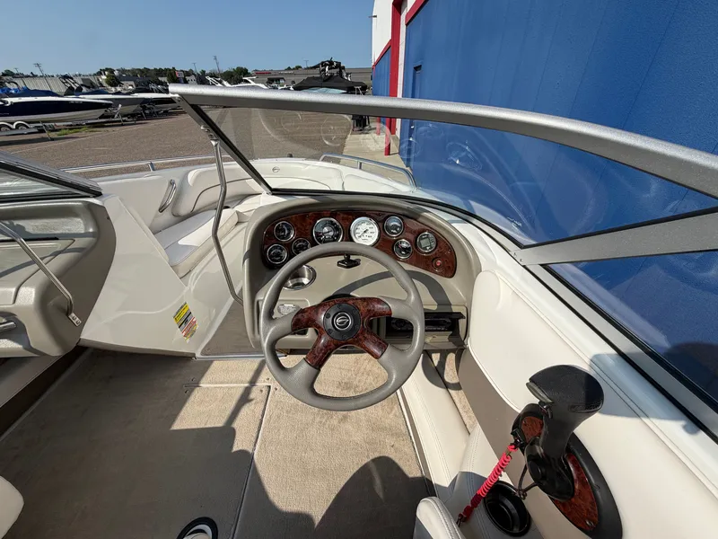 Slide: The Image of The image shows the cockpit of a 2006 Crownline 195 boat with a sleek dashboard. - 19
