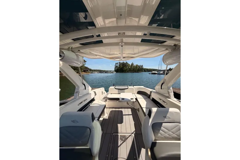Slide: The Image of 2023 Chaparral 307 SSX boat interior with luxurious seating and scenic lake view. - 6