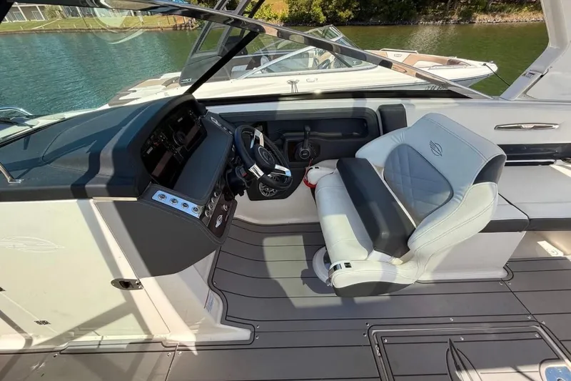 Slide: The Image of 2023 Chaparral 307 SSX boat cockpit with luxurious seating and modern dashboard controls. - 4