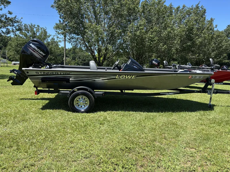 The Image of A 2018 Lowe Stinger 178 boat on a trailer on a grassy field. - 1