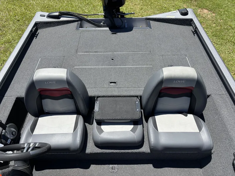 Slide: The Image of 2018 Lowe Stinger 178 with two gray seats and a small table in between. - 17