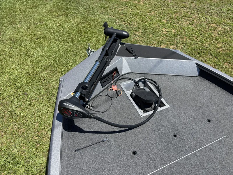 Slide: The Image of The image shows the deck of a 2018 Lowe Stinger 178 boat with a motor. - 15