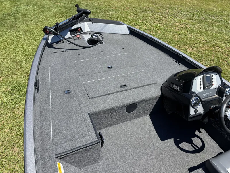 Slide: The Image of The image shows the deck of a 2018 Lowe Stinger 178 boat on grass. - 12