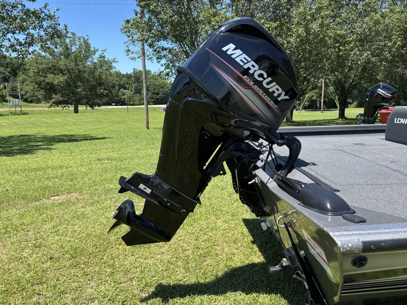 Slide: The Image of A 2018 Lowe Stinger 178 with a Mercury outboard motor on a grassy lawn. - 11