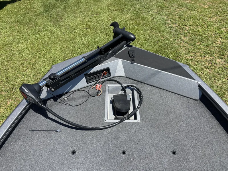 Slide: The Image of The image shows the bow deck of a 2018 Lowe Stinger 178 boat with a trolling motor. - 14