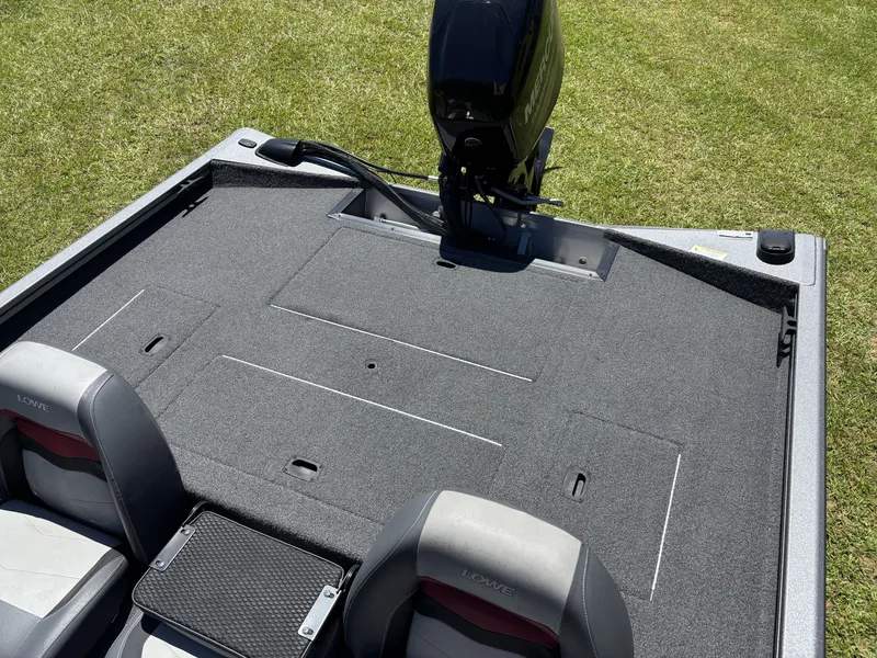 Slide: The Image of Rear view of a Lowe Stinger 178 boat with gray carpeting and two seats. - 18