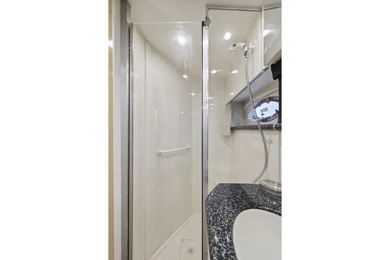 Slide: The Image of Luxurious bathroom in 2000 Carver 406 Aft Cabin Motor Yacht with modern shower and sleek countertop. - 68