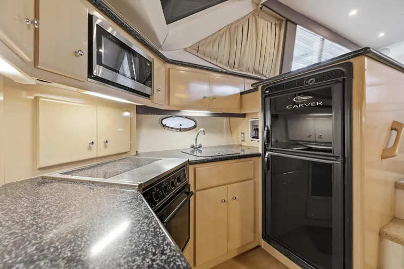 Slide: The Image of Interior of 2000 Carver 406 Aft Cabin Motor Yacht kitchen with modern appliances. - 53