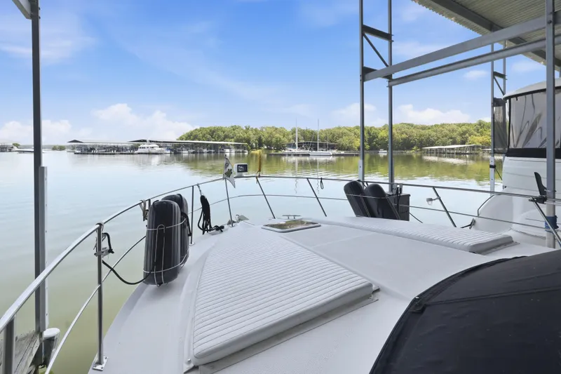 Slide: The Image of Carver 406 Aft Cabin Motor Yacht 2000 docked at a serene marina under blue skies. - 40