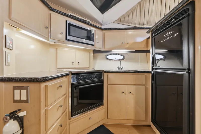 Slide: The Image of Modern kitchen in 2000 Carver 406 Aft Cabin Motor Yacht with appliances and cabinetry. - 52