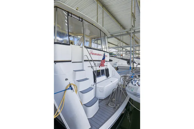 Slide: The Image of Carver 406 Aft Cabin Motor Yacht 2000 docked, featuring aft deck and steps. - 39
