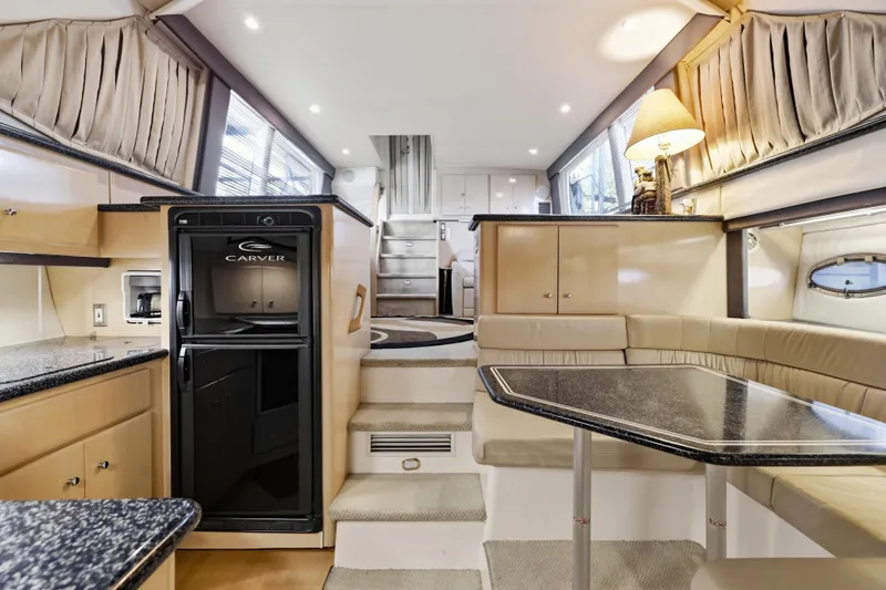 Slide: The Image of Interior of 2000 Carver 406 Aft Cabin Motor Yacht with modern kitchen and seating area. - 50