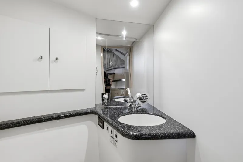Slide: The Image of Luxurious bathroom in 2000 Carver 406 Aft Cabin Motor Yacht with sleek countertop and mirror. - 58
