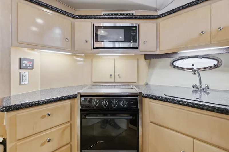 Slide: The Image of Modern kitchen in 2000 Carver 406 Aft Cabin Motor Yacht with microwave and stove. - 60