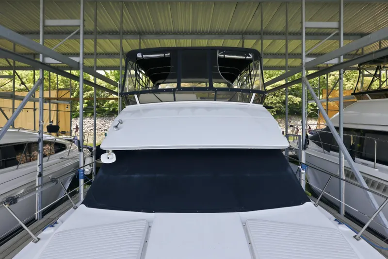 Slide: The Image of 2000 Carver 406 Aft Cabin Motor Yacht docked in covered marina. - 42