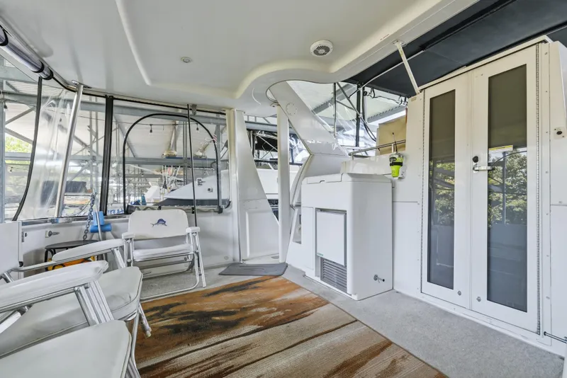 Slide: The Image of 2000 Carver 406 Aft Cabin Motor Yacht interior with seating and glass doors. - 24