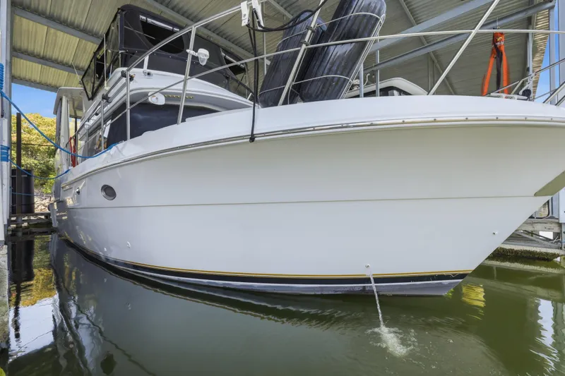 Slide: The Image of 2000 Carver 406 Aft Cabin Motor Yacht docked under a covered marina. - 34