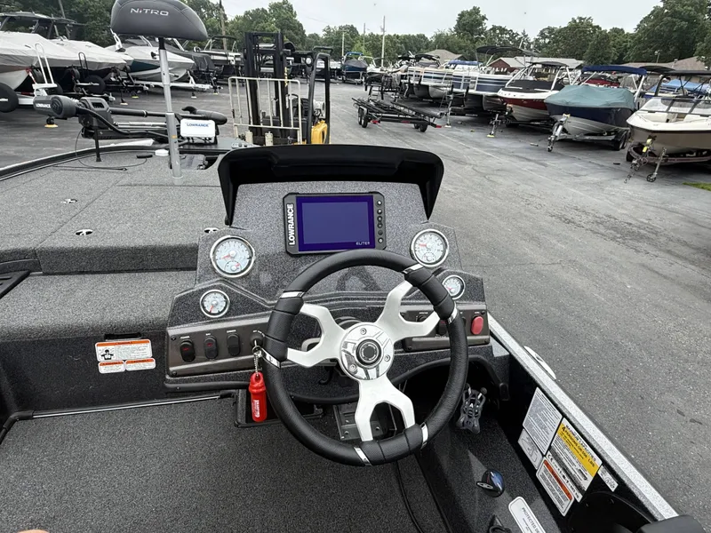 Slide: The Image of 2023 Nitro Z18 Pro with modern helm and electronics, surrounded by other boats in a parking area. - 6