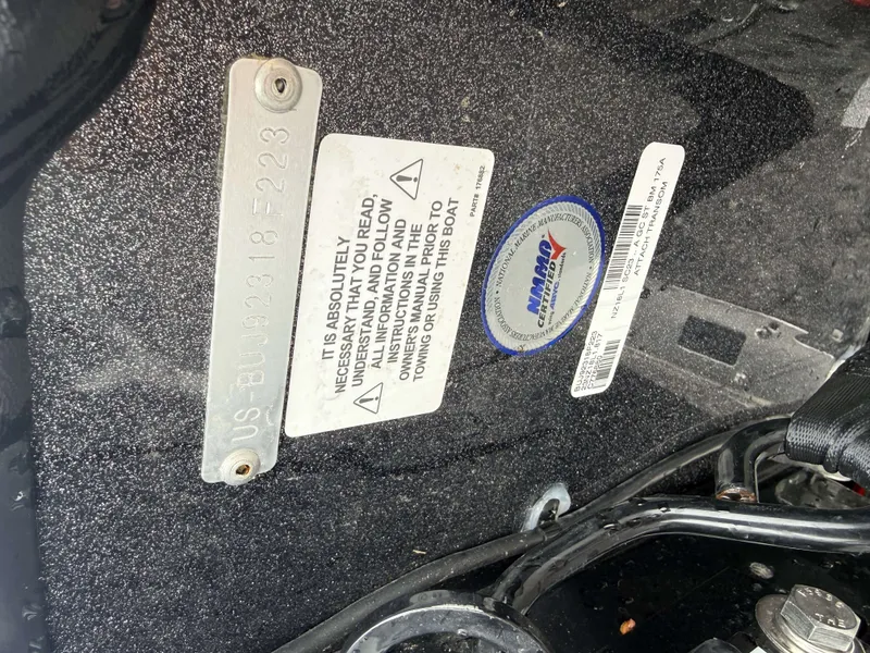 Slide: The Image of Interior view of a Nitro Z18 Pro boat with warning labels and manufacturer tags. - 17