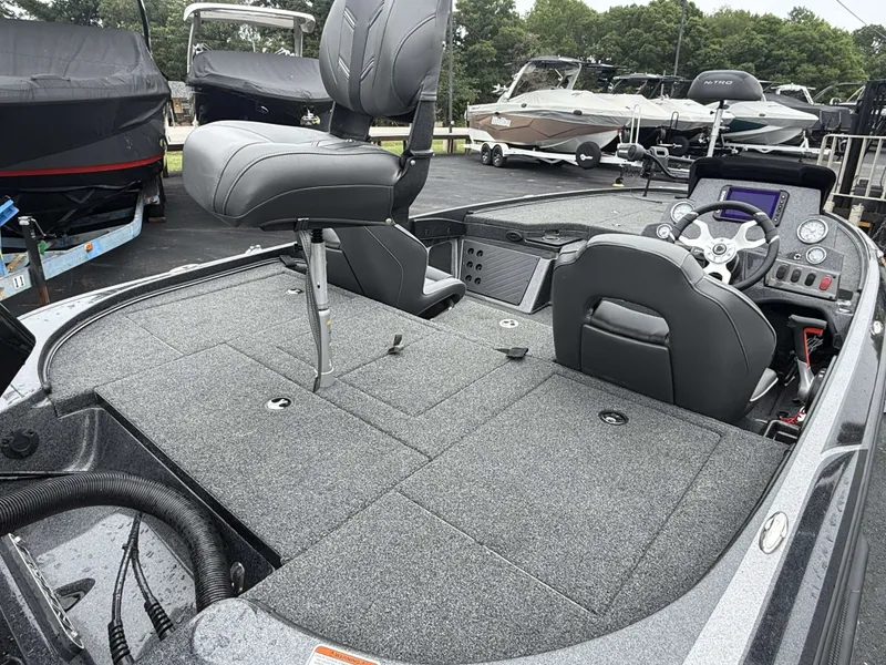 Slide: The Image of 2023 Nitro Z18 Pro: Spacious deck with gray carpet and two seats, ideal for fishing. - 20