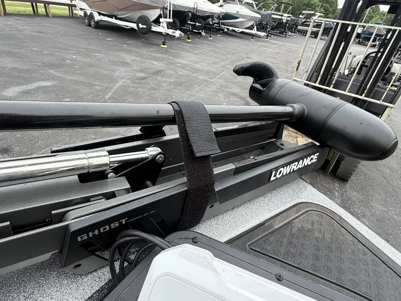 Slide: The Image of Close-up of a boat motor with Lowrance branding, on a parking lot with other boats. - 13